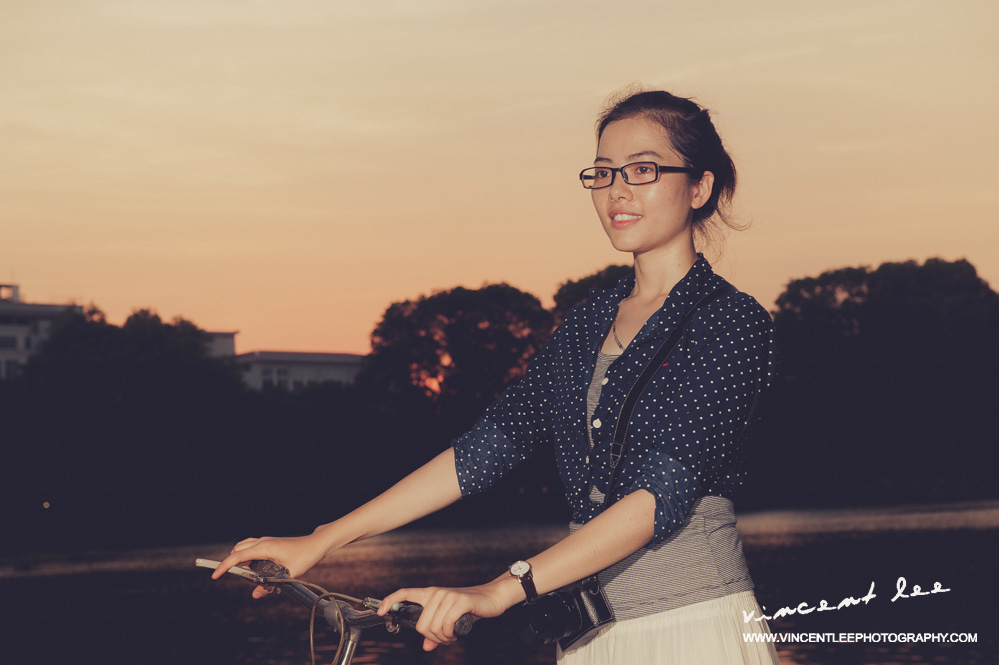 Vietnamese modern looking girl with her bicycle at Ho Kiem Lake - Hanoi