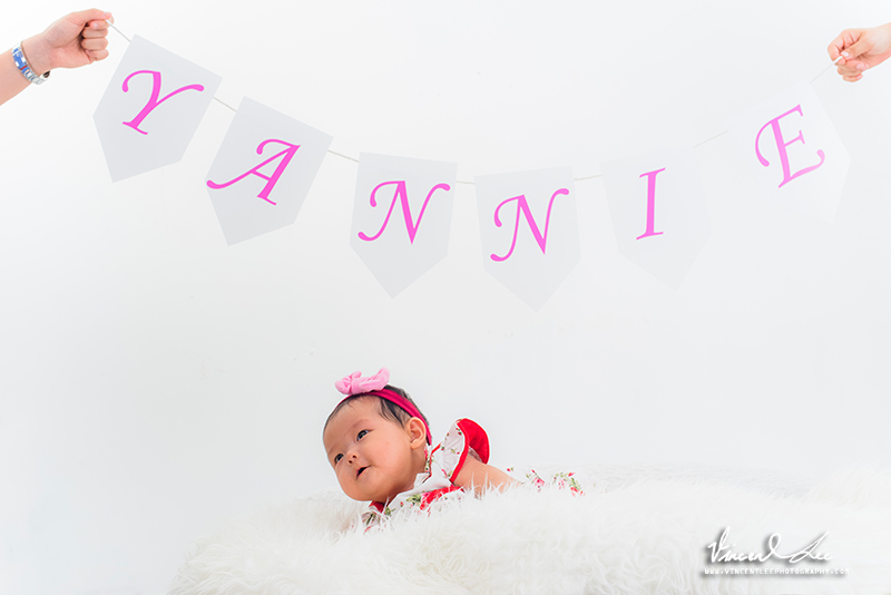 Yankee looking up to her parents holding the letters belongs to her name